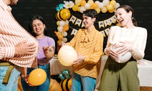 a group of people standing next to each other holding balloons