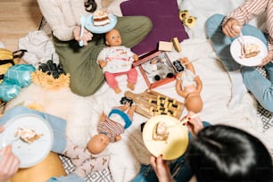 a group of people sitting on the floor eating cake