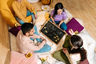 a group of people sitting around a blackboard