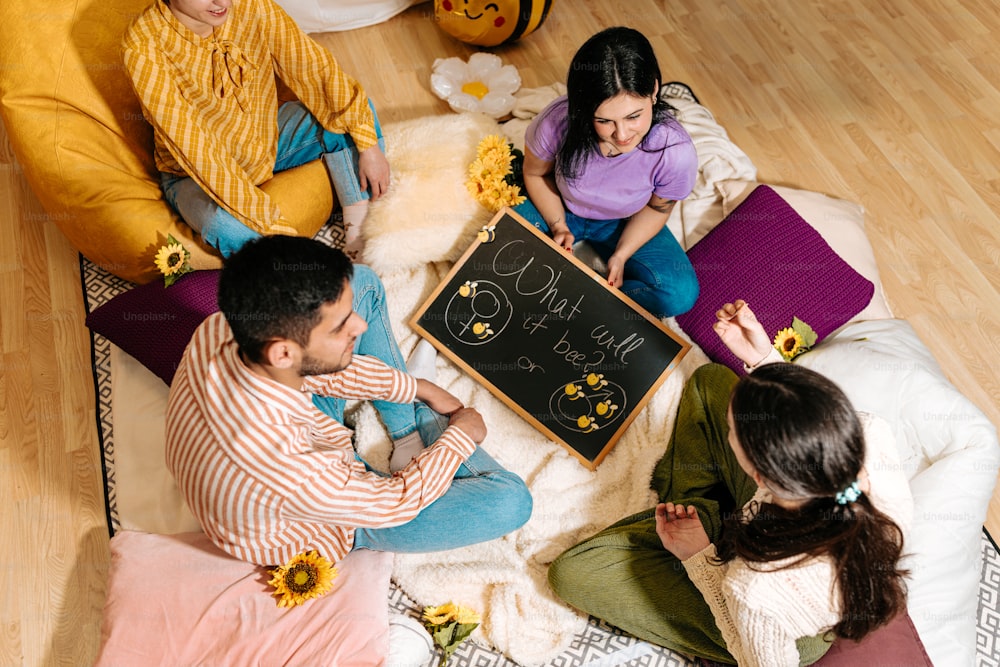 a group of people sitting around a blackboard