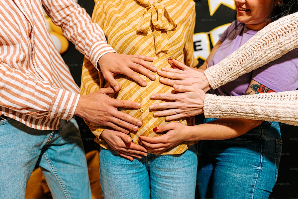 a group of people putting their hands together