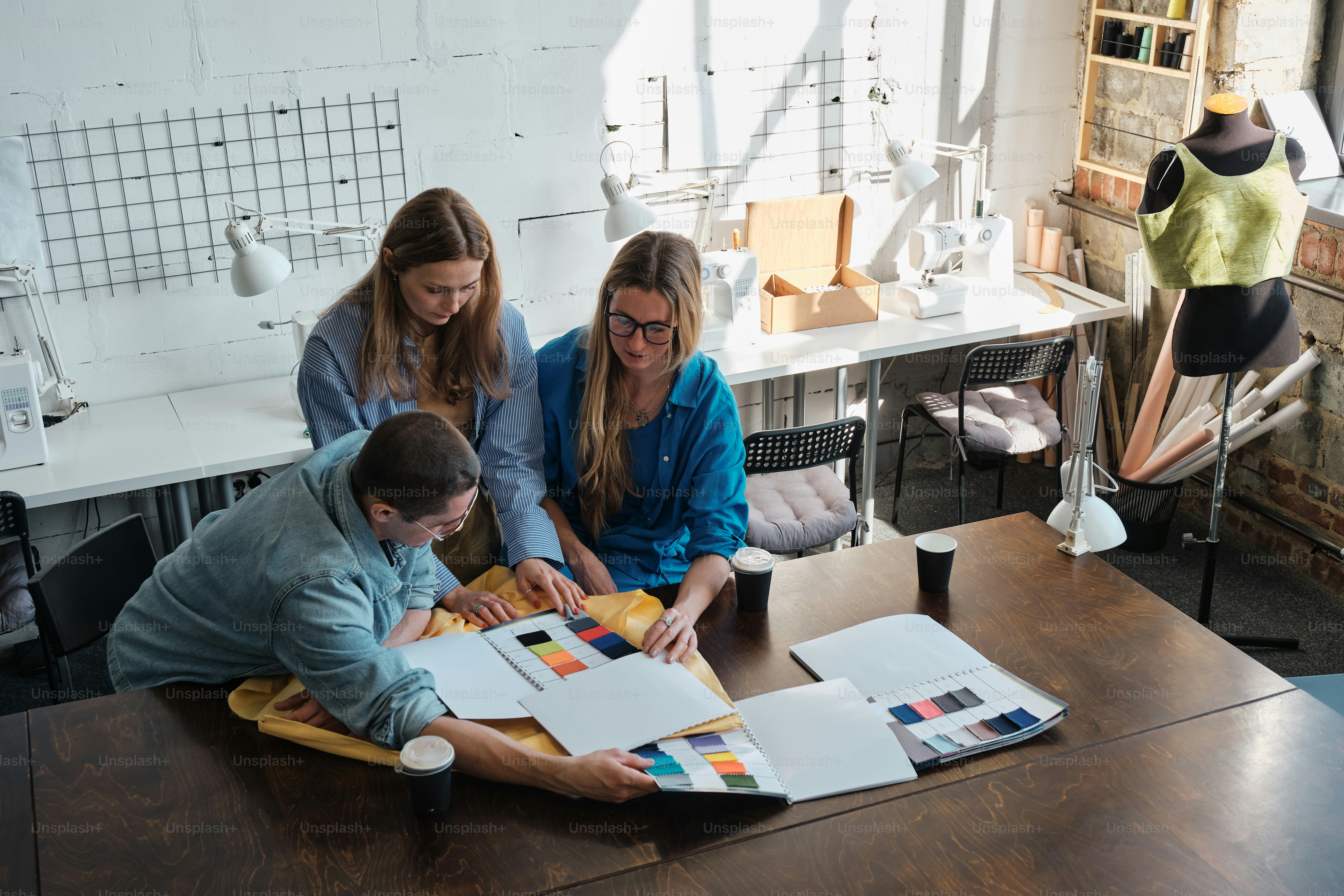 a group of people sitting around a wooden table