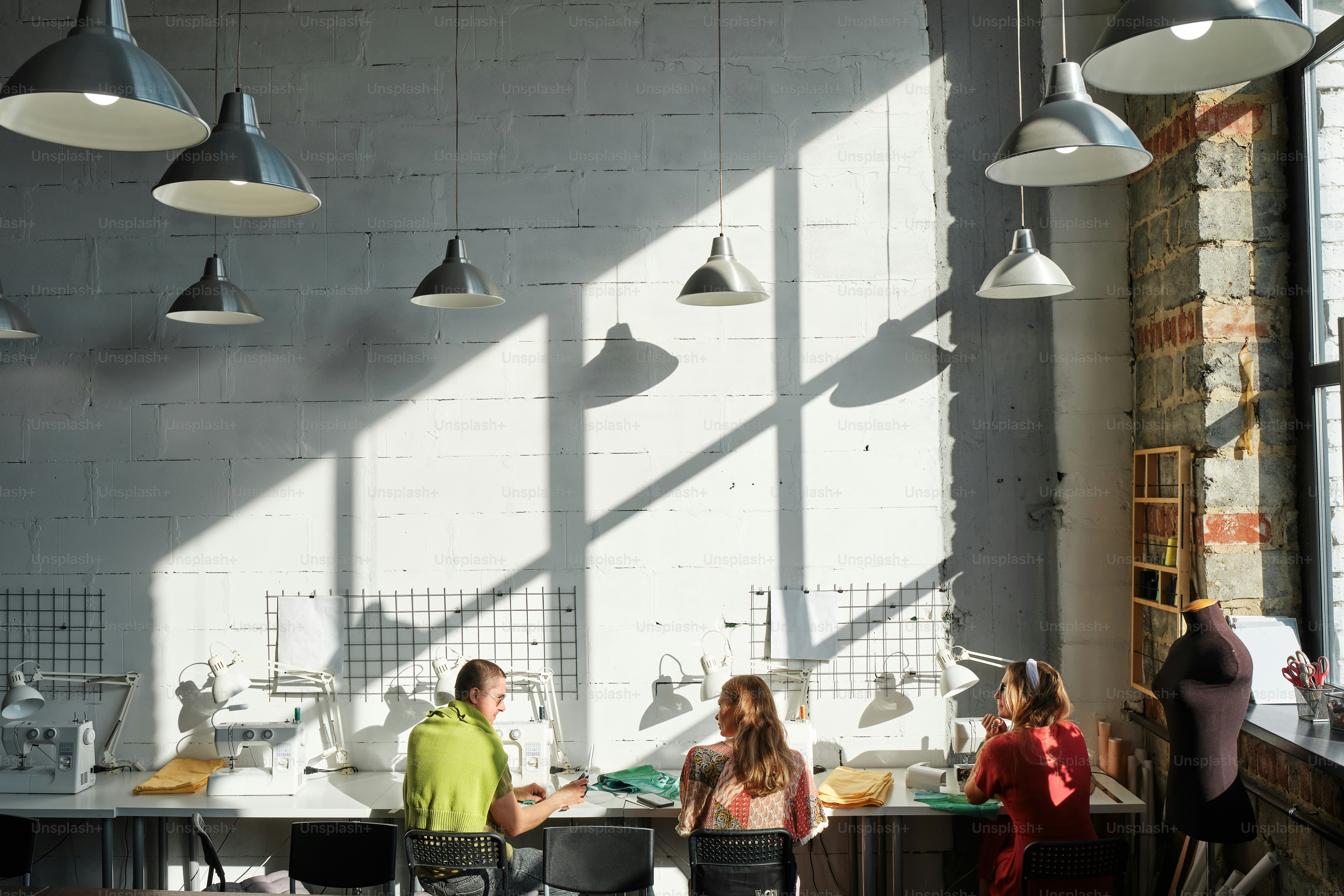 a group of people standing around a kitchen