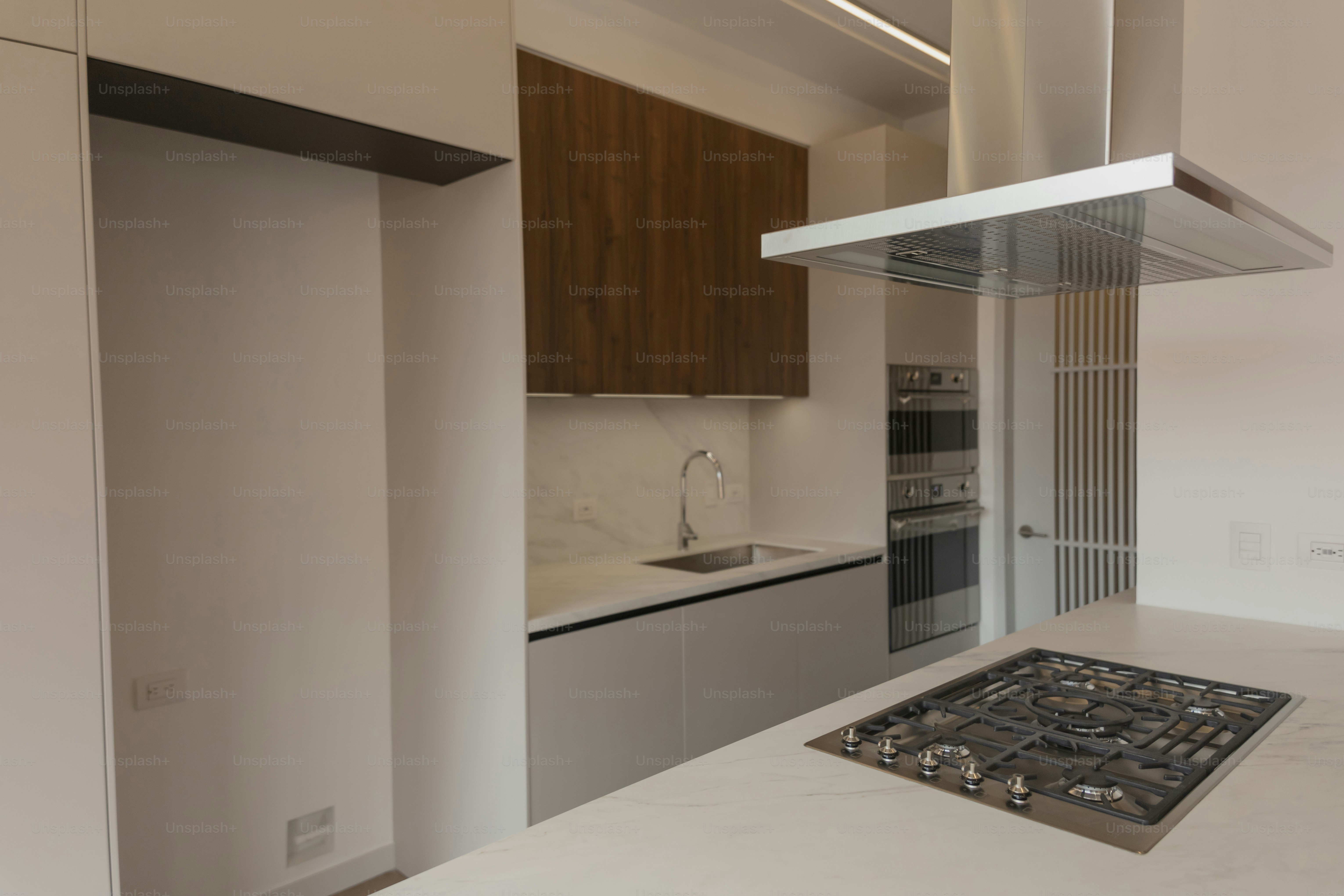 a kitchen with a stove top oven next to a sink