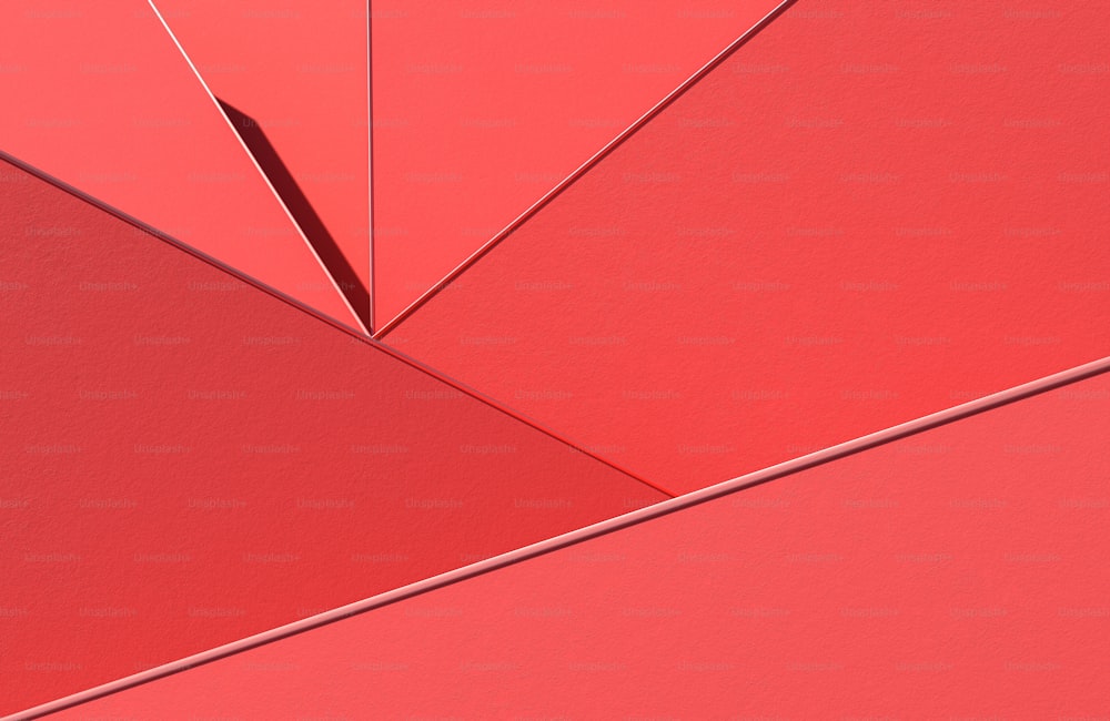 Un primer plano de una pared roja con un paraguas rojo