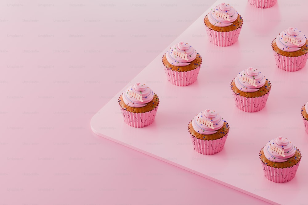 a tray of cupcakes with pink frosting