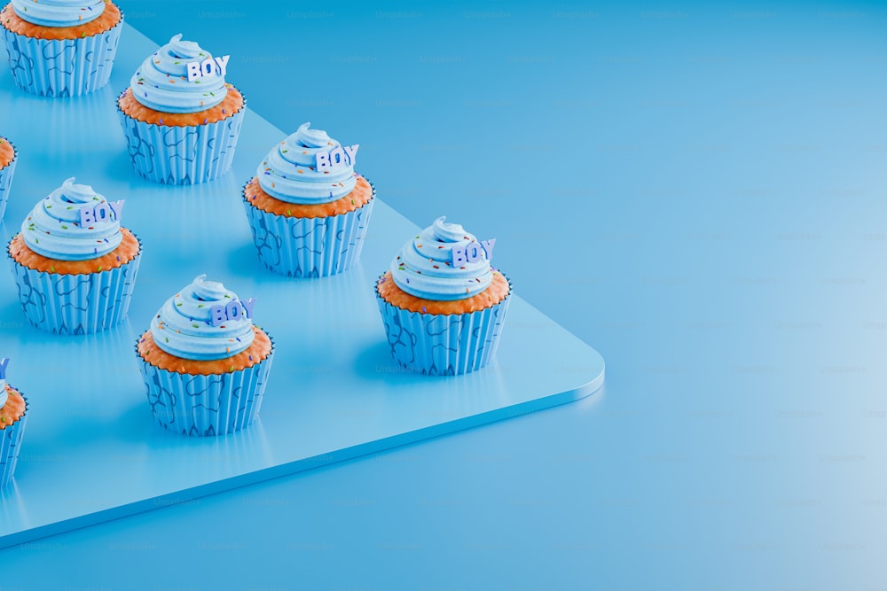 cupcakes are arranged on a blue tray