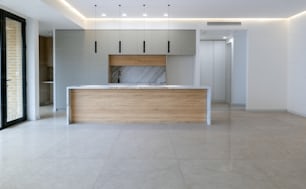 an empty kitchen with a marble counter top