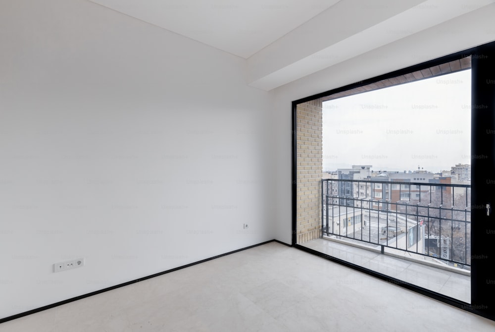 an empty room with a large sliding glass door