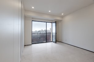 an empty room with a large window overlooking the city