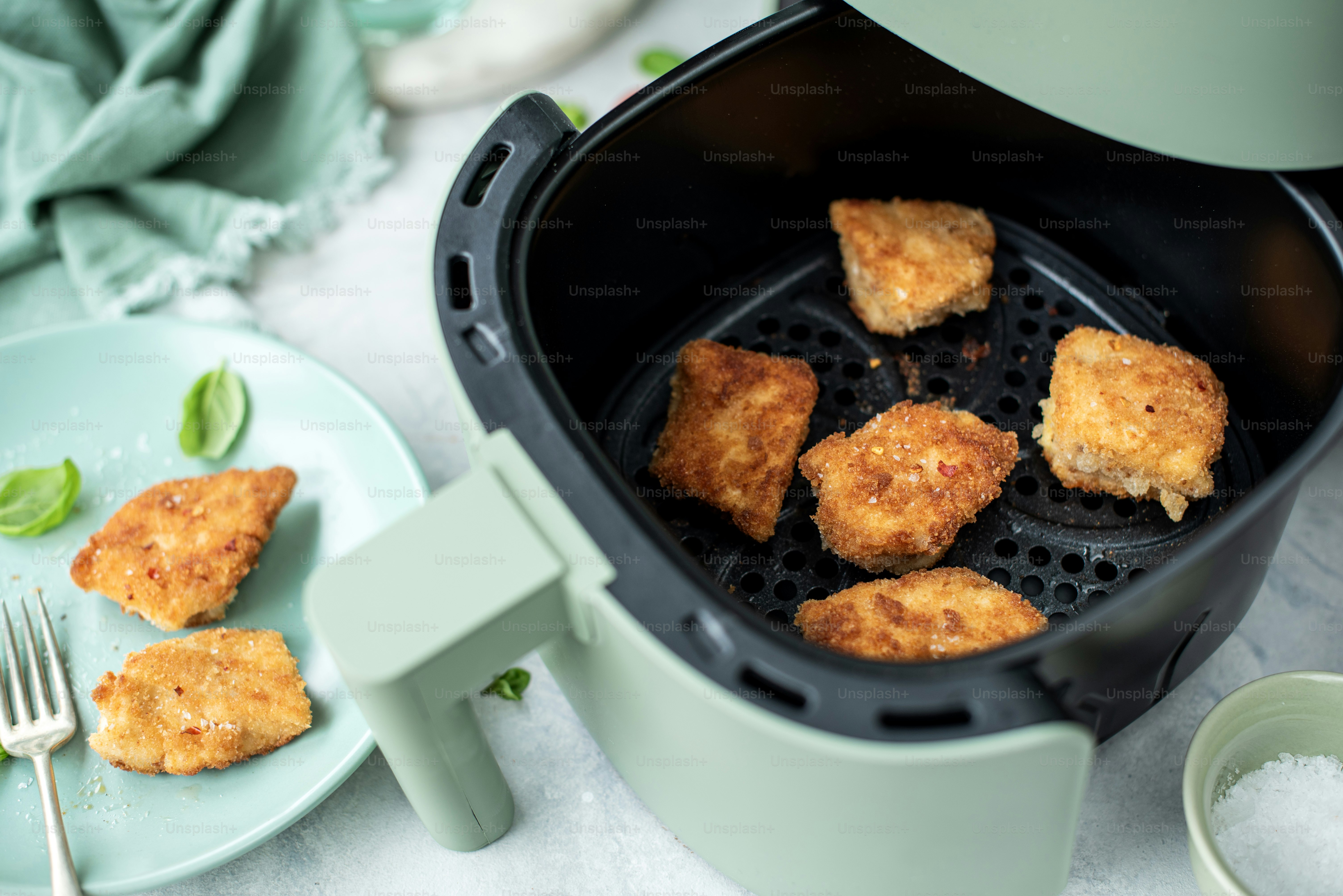 a close up of food in a fryer on a plate