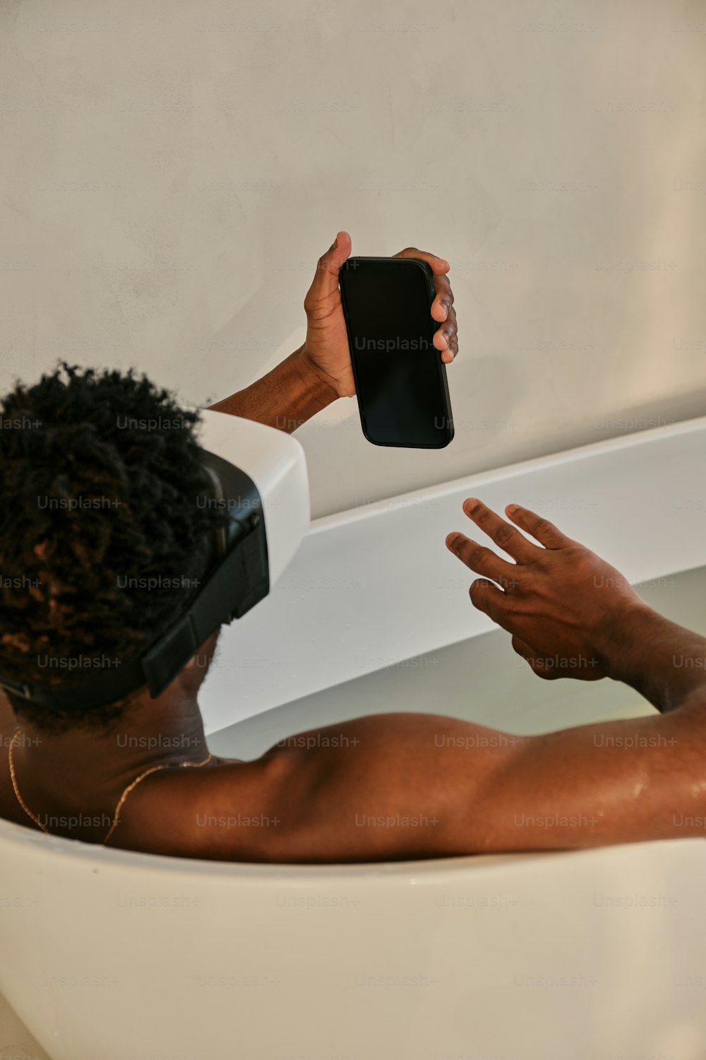 a man taking a selfie in a bathtub
