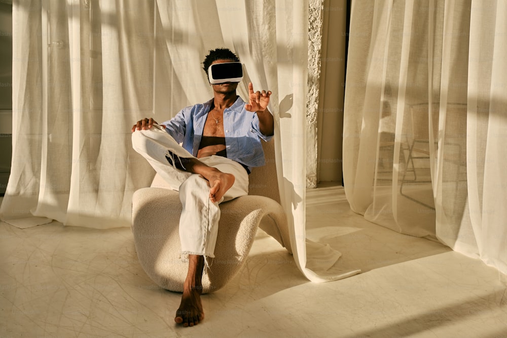 a man sitting in a chair wearing a blindfold