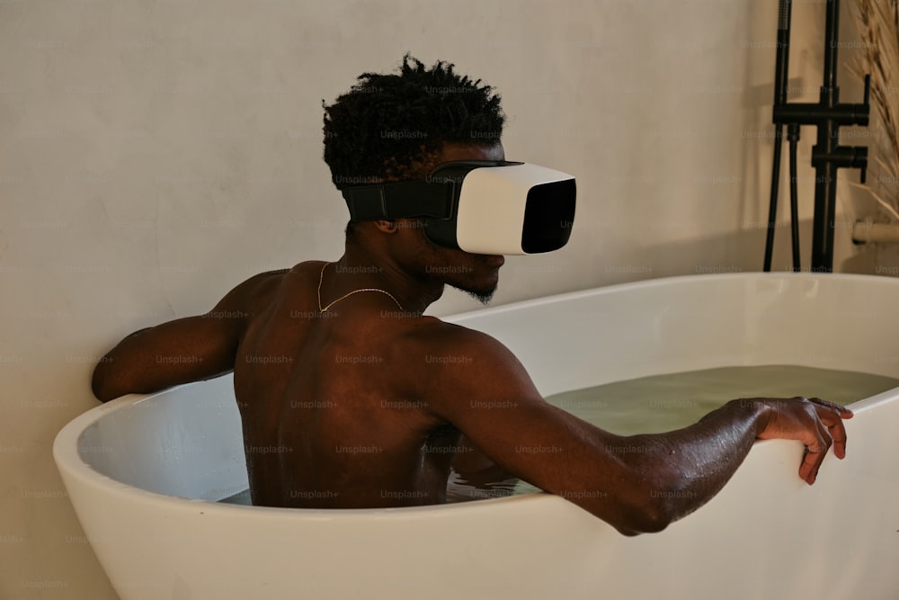 a man in a bathtub with a pair of virtual glasses on his head