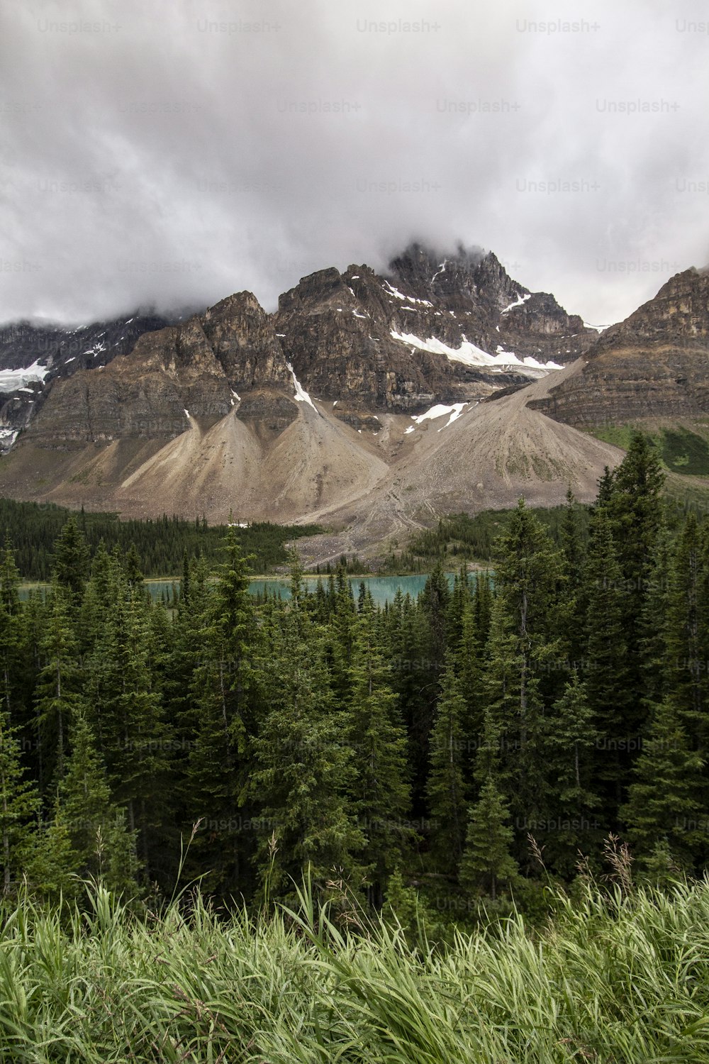 a view of a mountain range with a lake in the foreground