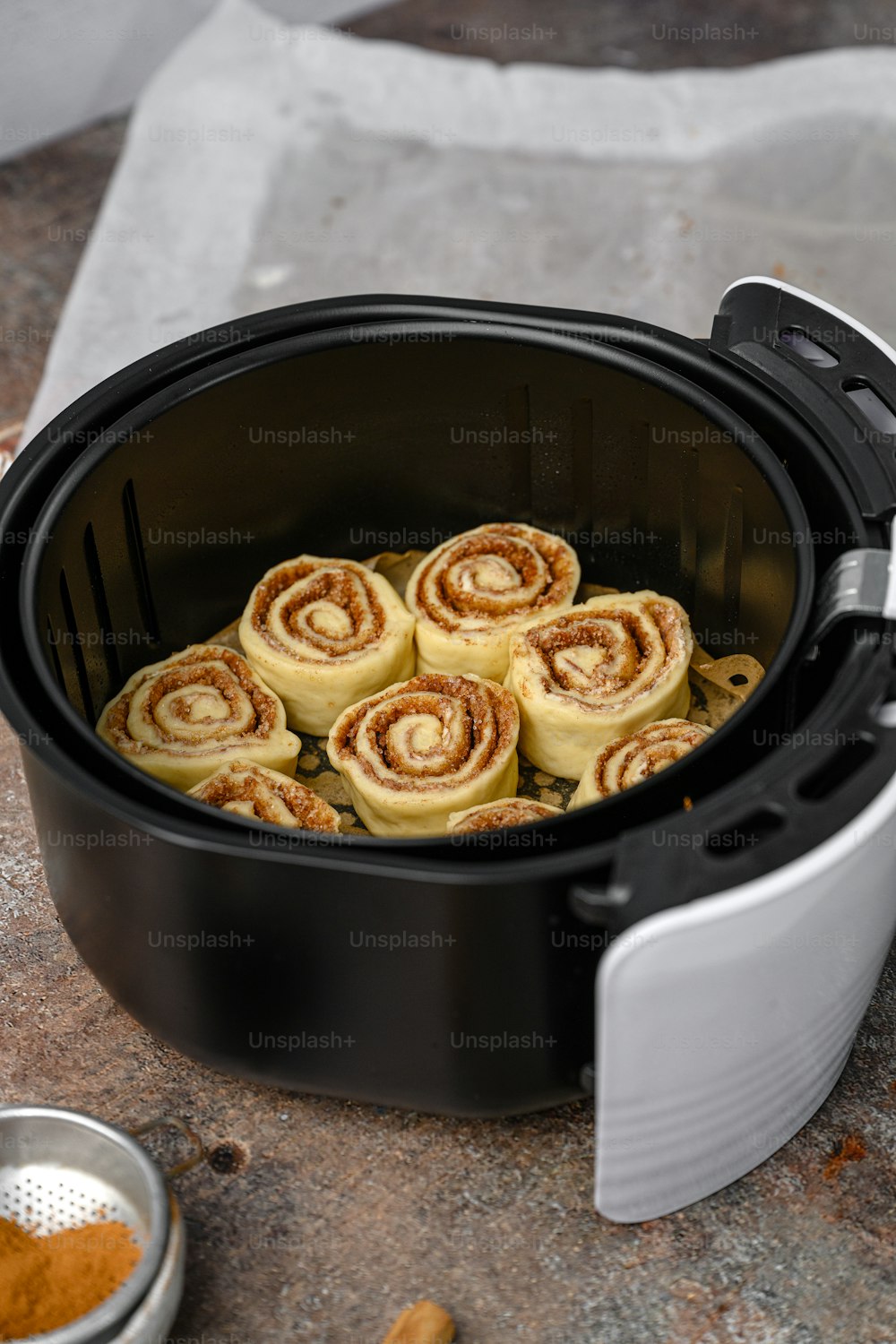 a slow cooker filled with cinnamon rolls and spices