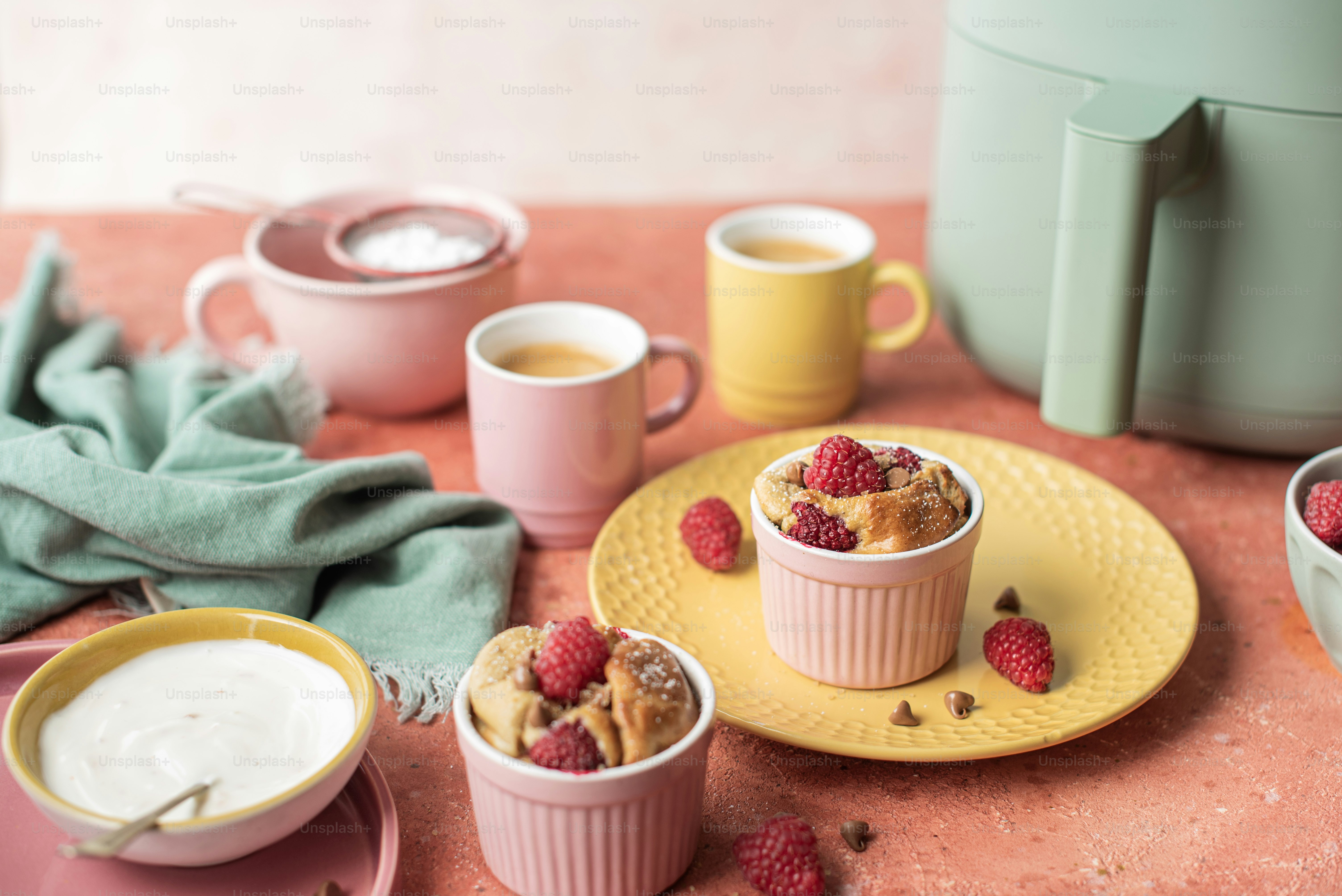 a table topped with bowls of food and cups of coffee