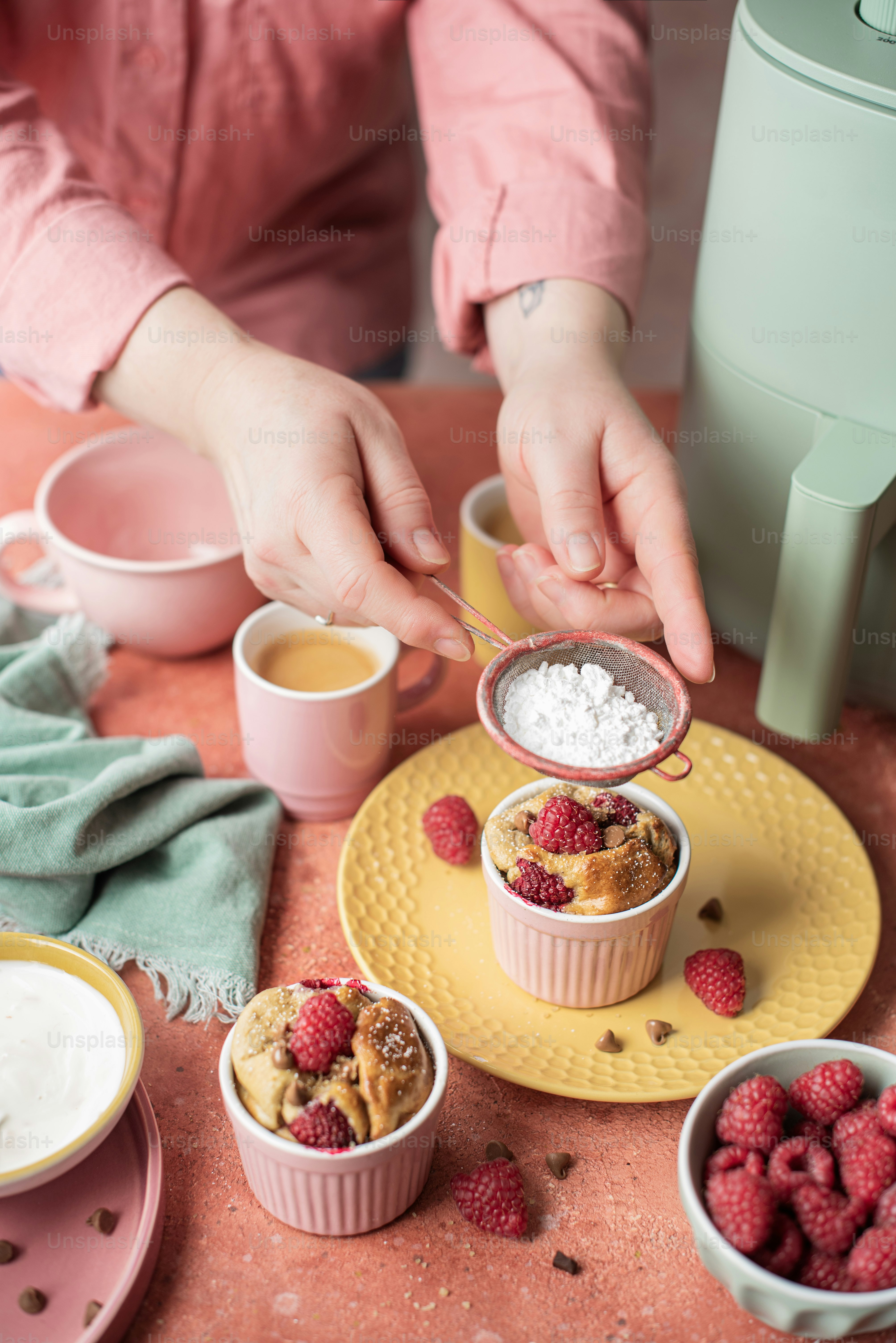 a person scooping sugar into small bowls of food