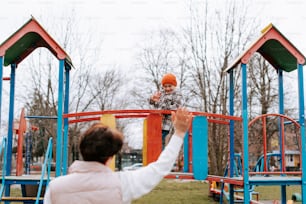 a woman and a child playing in a park