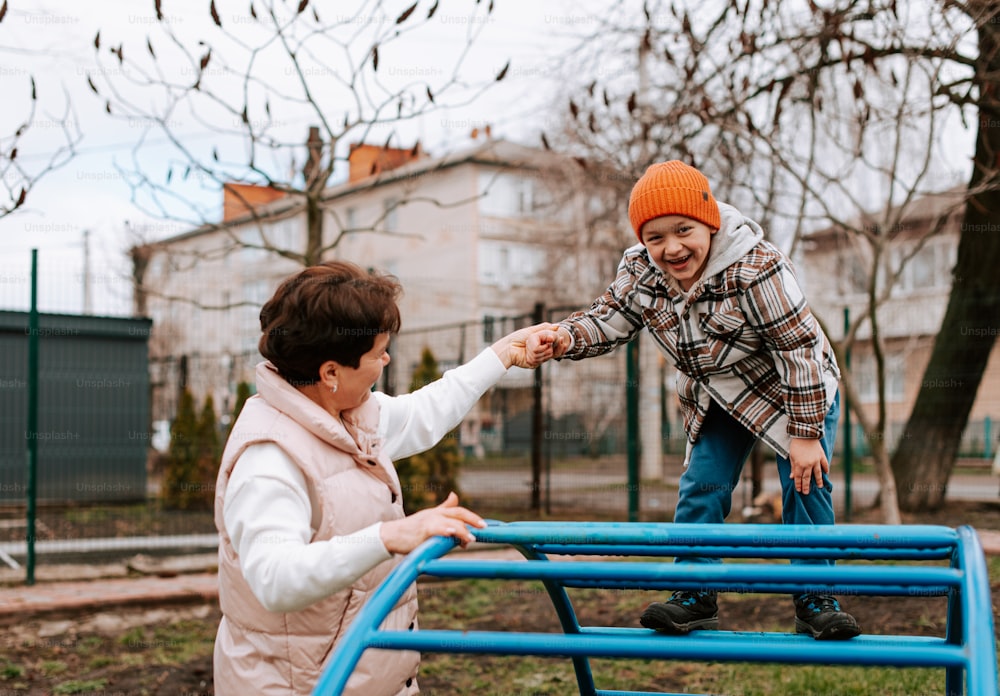 an older woman and a young boy playing in a park