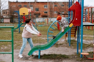 a man and a woman playing on a playground