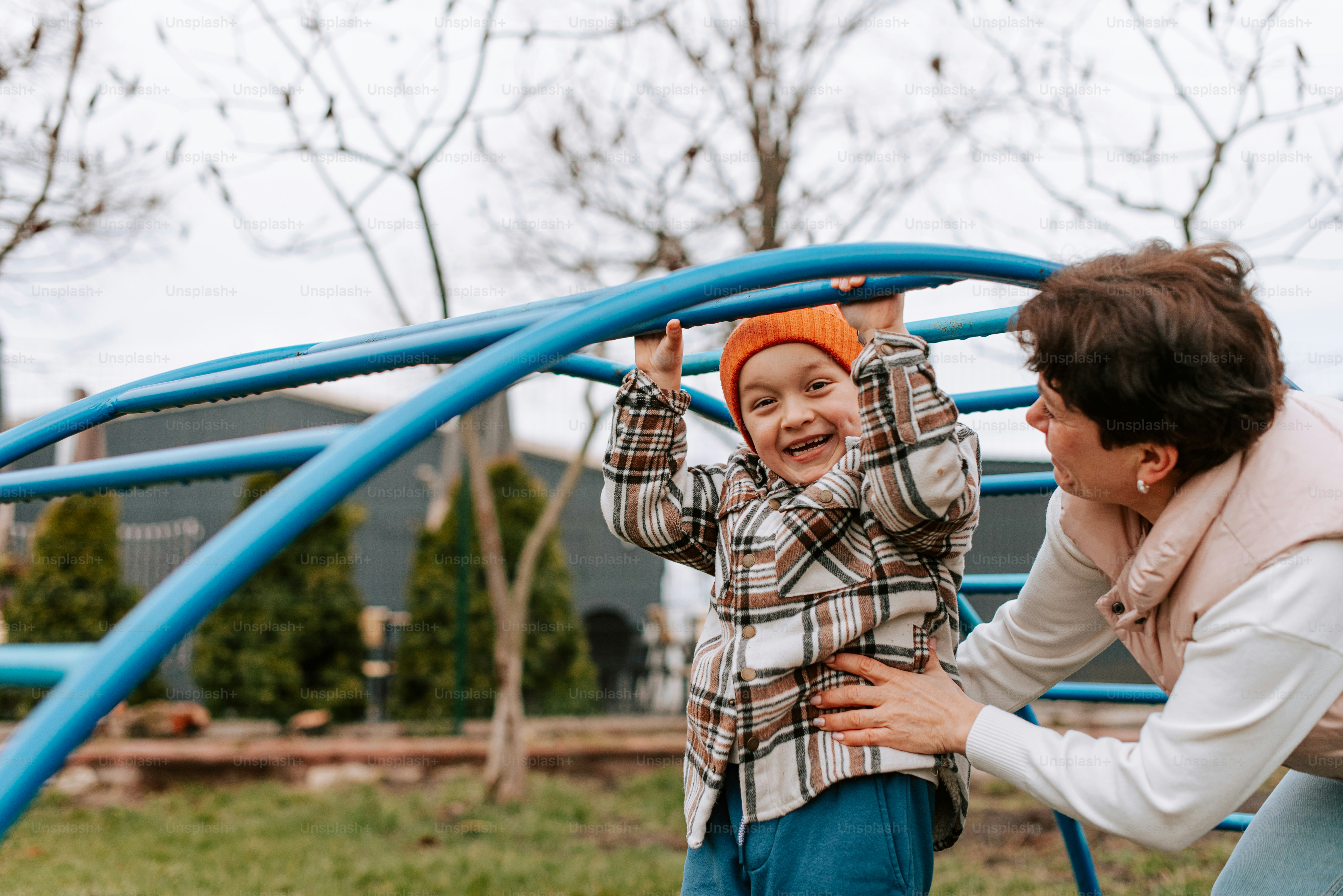 a woman and a child playing on a playground