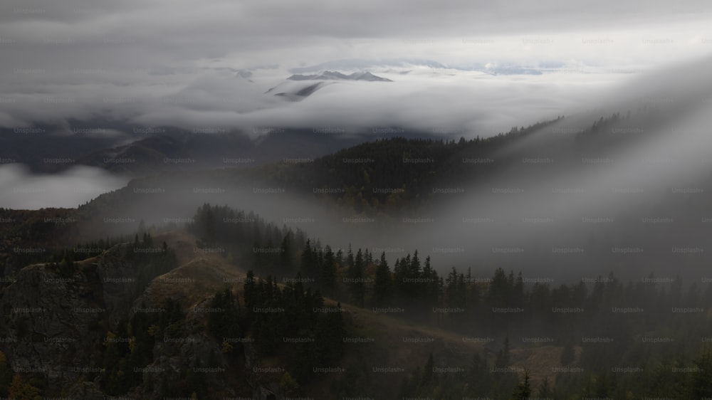 a view of a mountain covered in low lying clouds