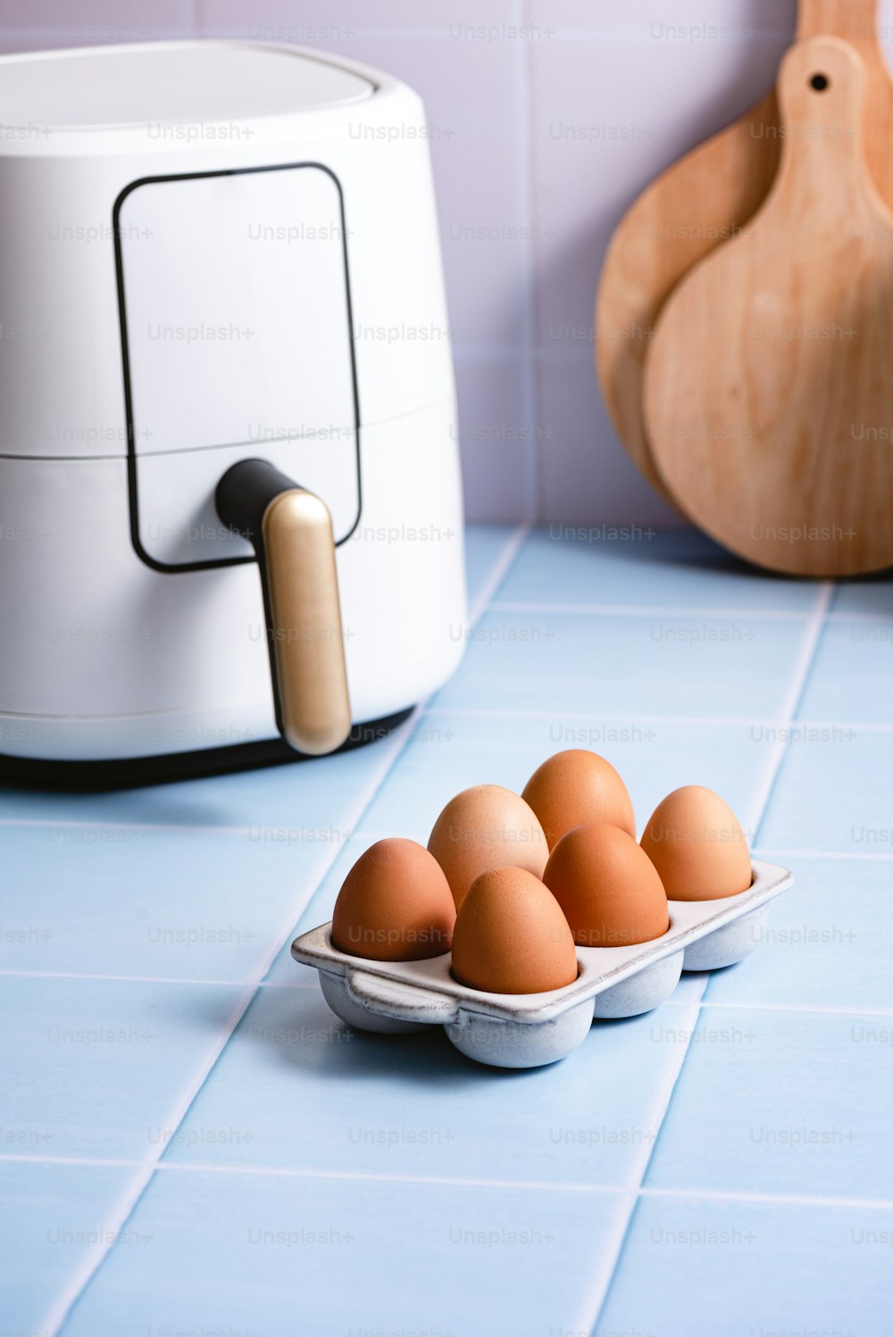 a plate of eggs sitting on a blue tiled counter