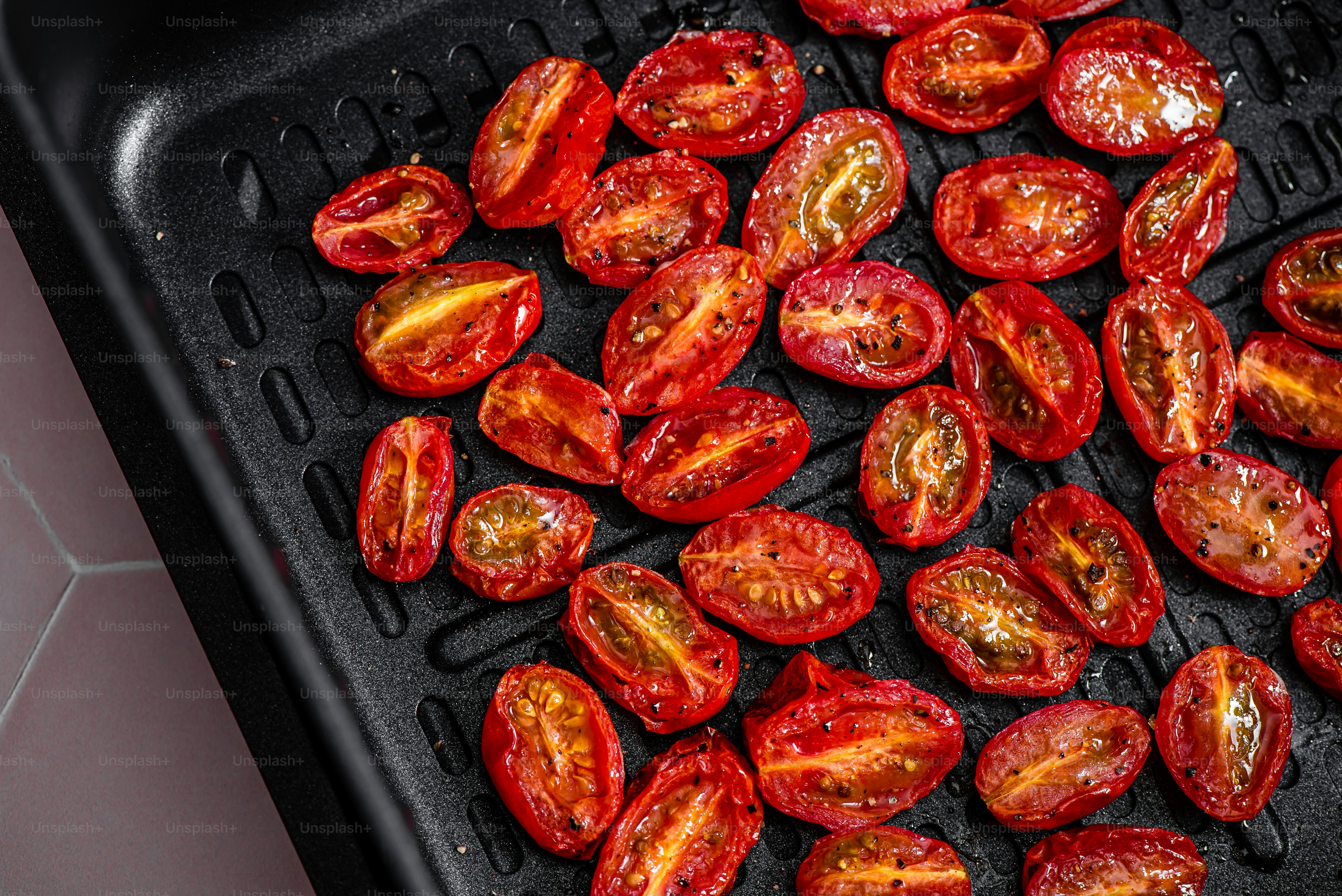 a pan filled with sliced tomatoes on top of a table