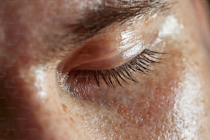 a close up of a person's eye with long eyelashes
