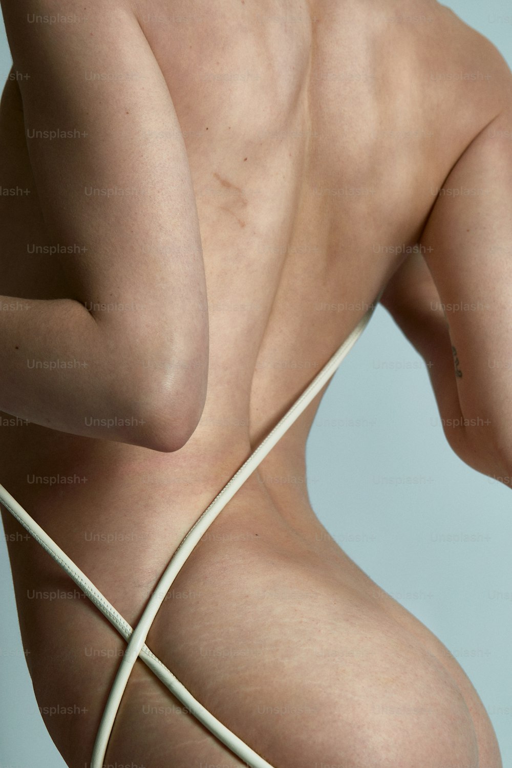 a naked woman with a white string around her back