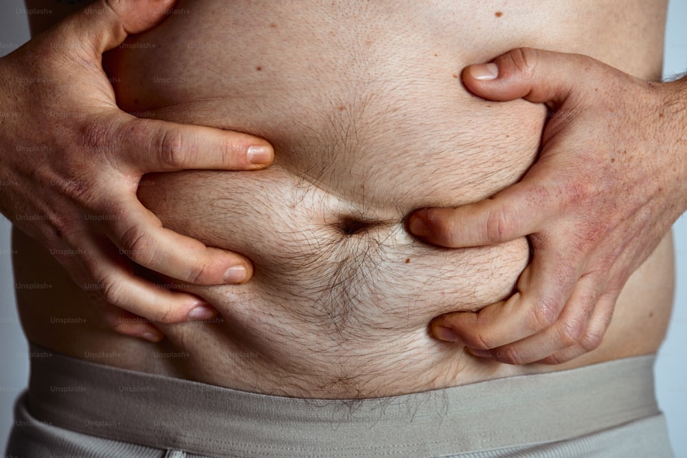 a close up of a person holding their stomach
