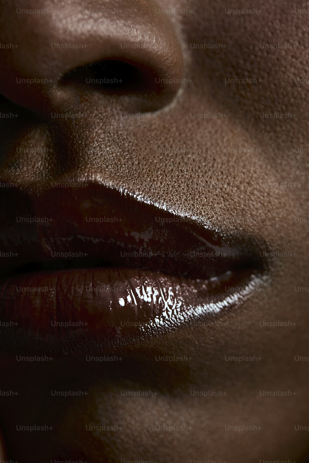 a close up of a woman's face with a shiny lip