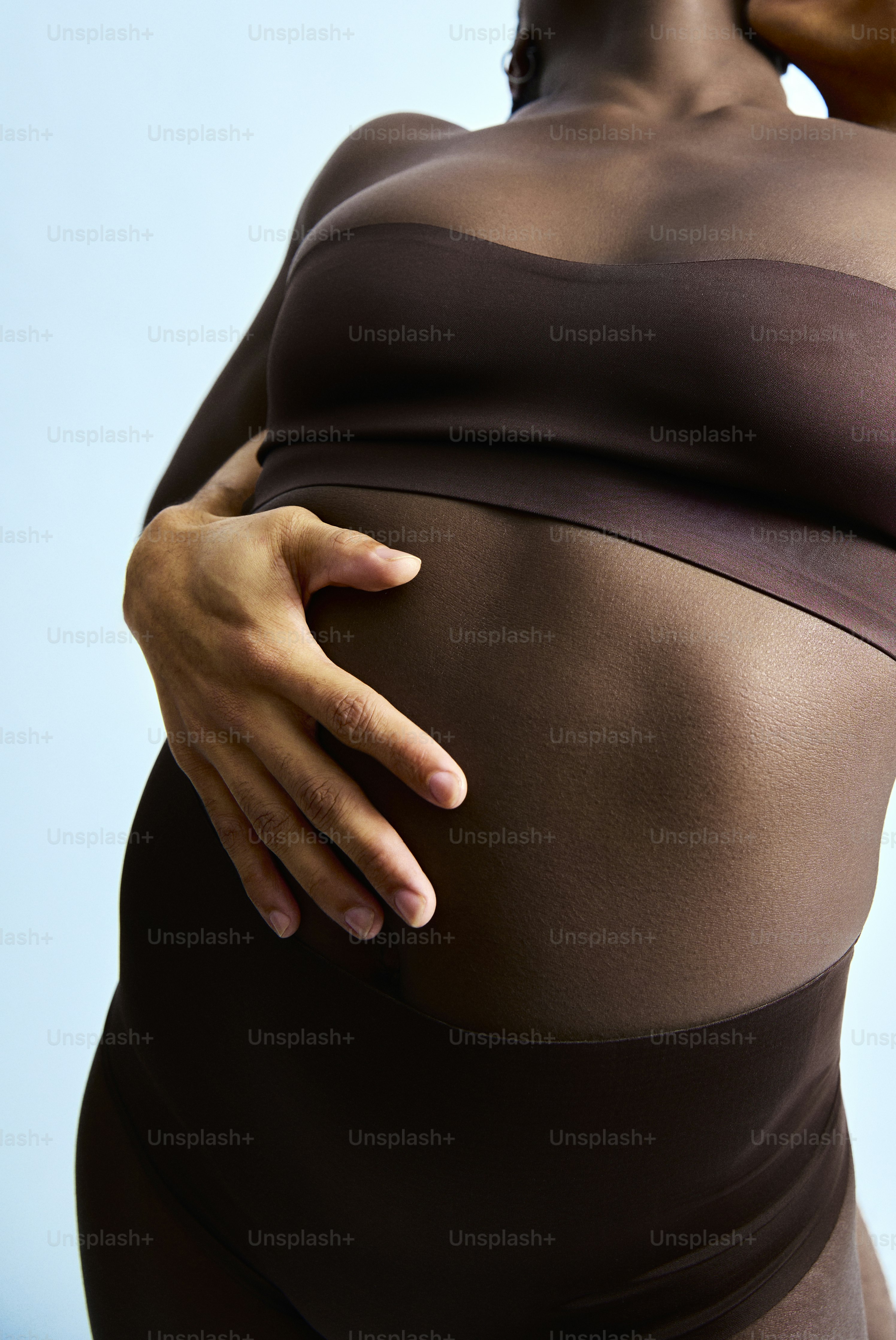 a pregnant woman with her hand on her belly