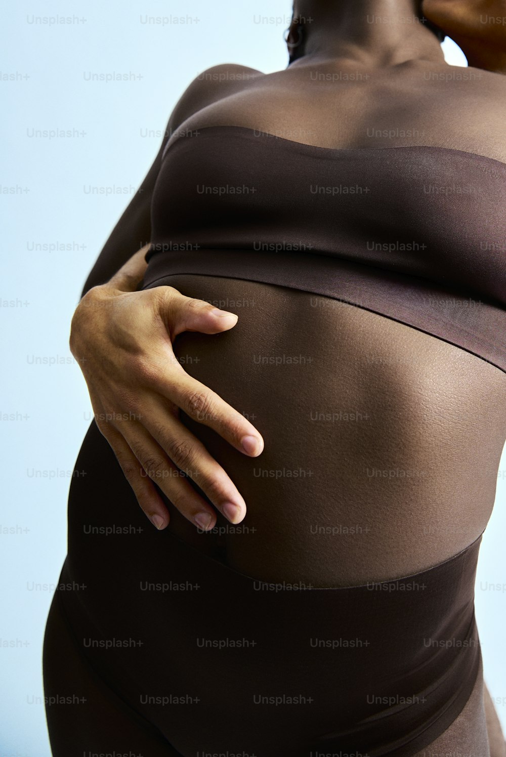 a pregnant woman with her hand on her belly