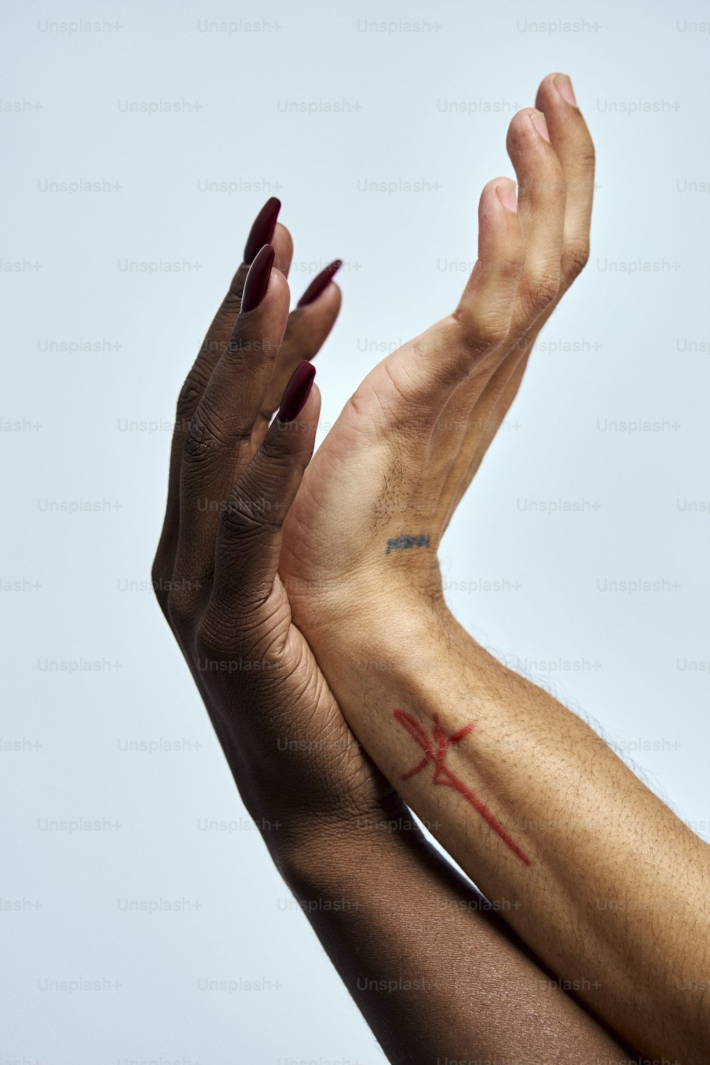 a woman's arm with a cross tattoo on it