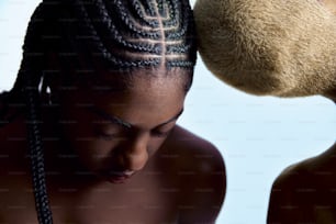 a woman with braids and a teddy bear