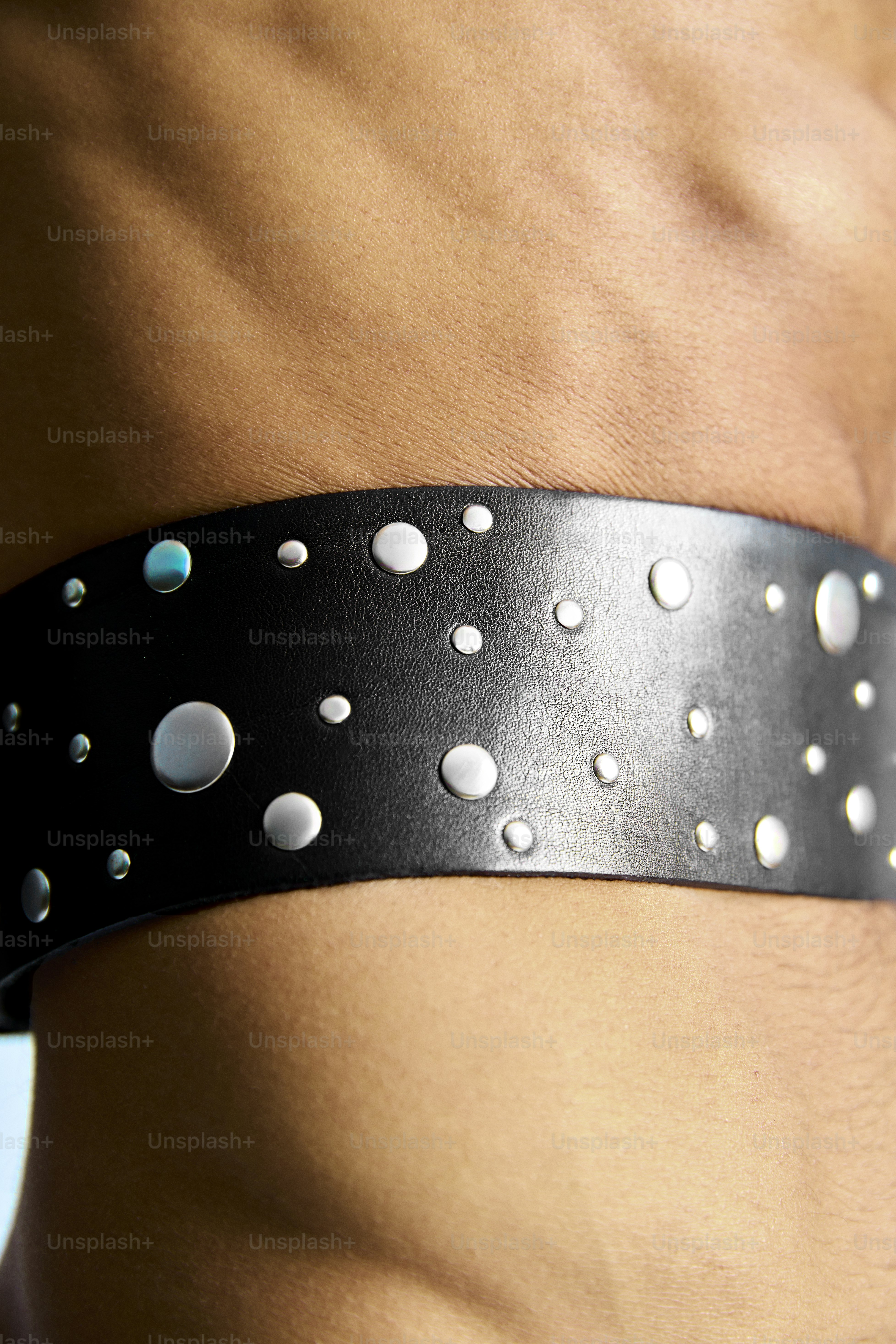 a close up of a person wearing a leather belt