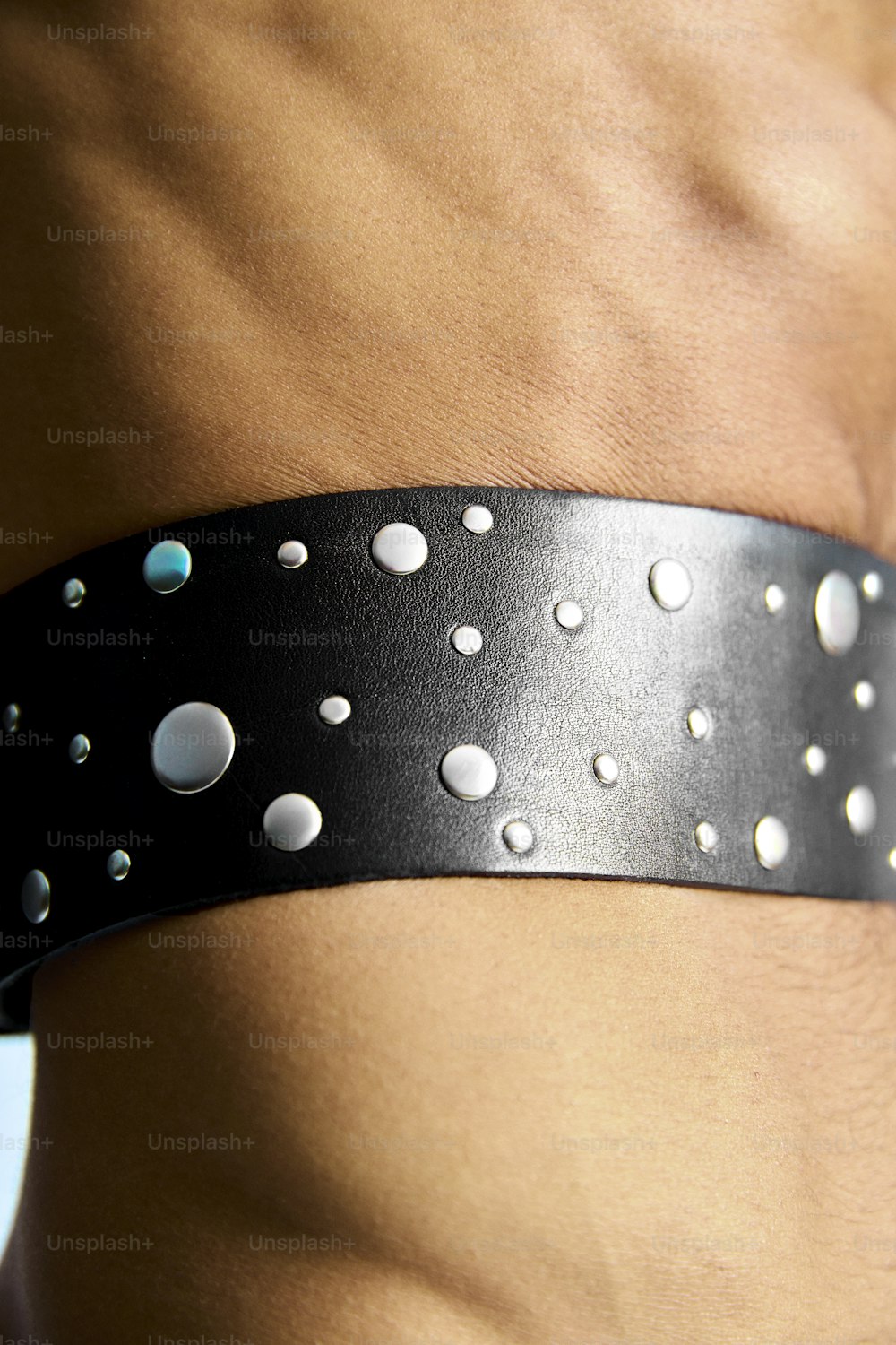 a close up of a person wearing a leather belt