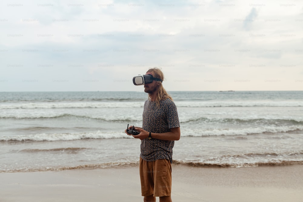 a man standing on a beach with a camera