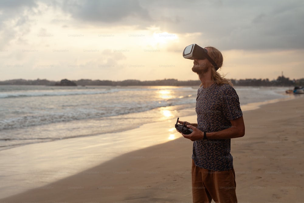 a man standing on a beach holding a camera