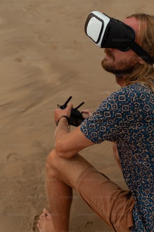 a man sitting on a beach wearing a pair of virtual glasses