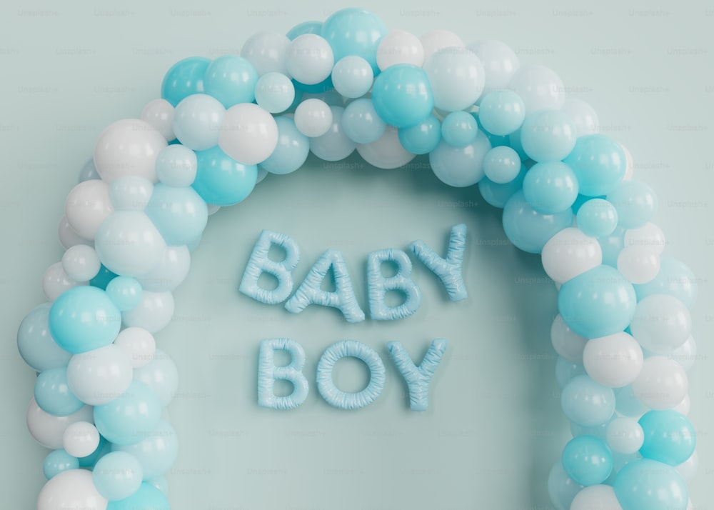 a blue and white balloon arch with the words baby boy