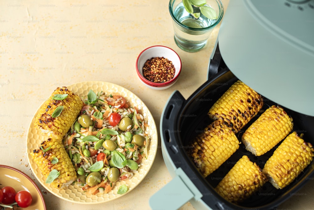 corn on the cob and a plate of vegetables