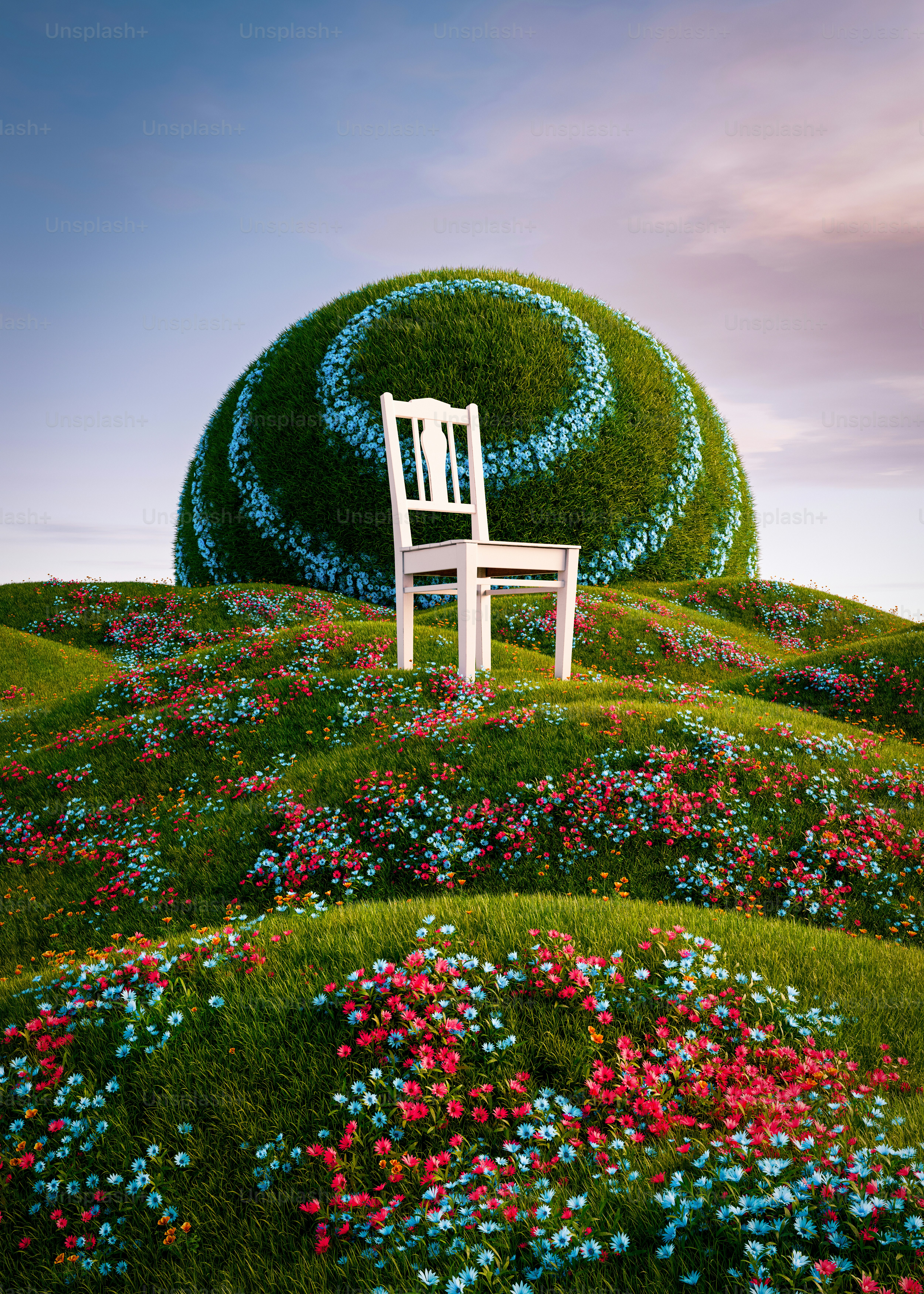 a white chair sitting on top of a lush green hillside