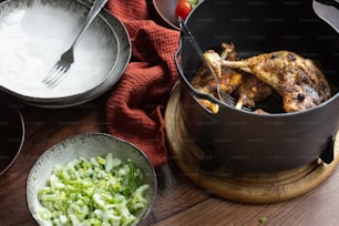 a wooden table topped with bowls of food