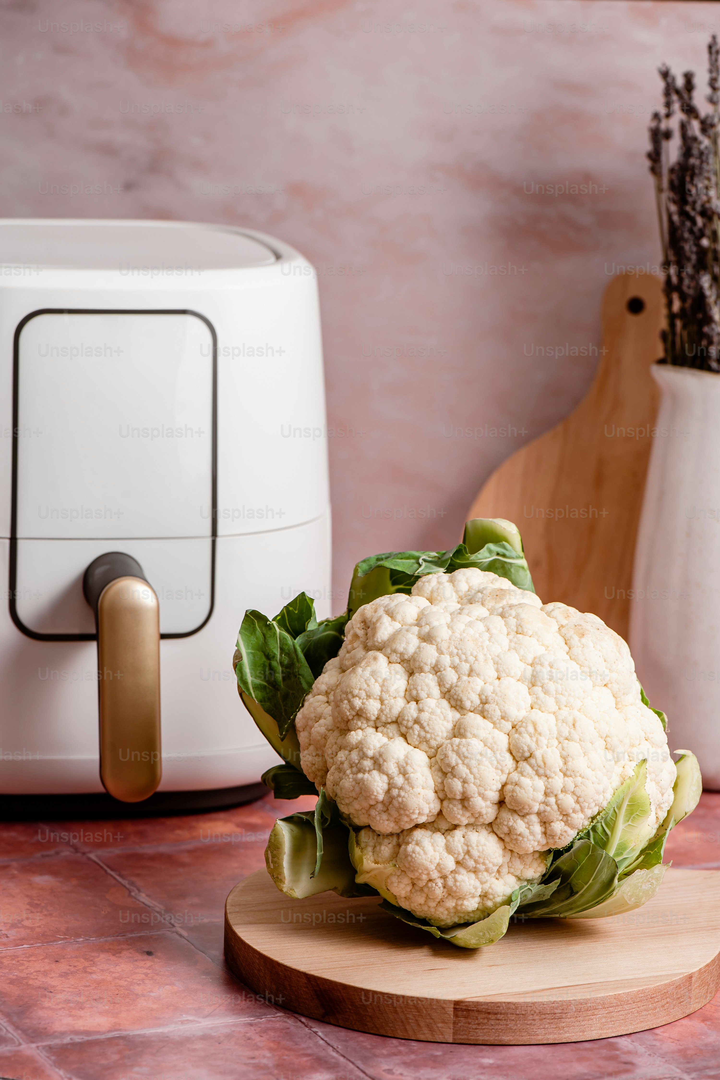 a close up of a cauliflower on a cutting board