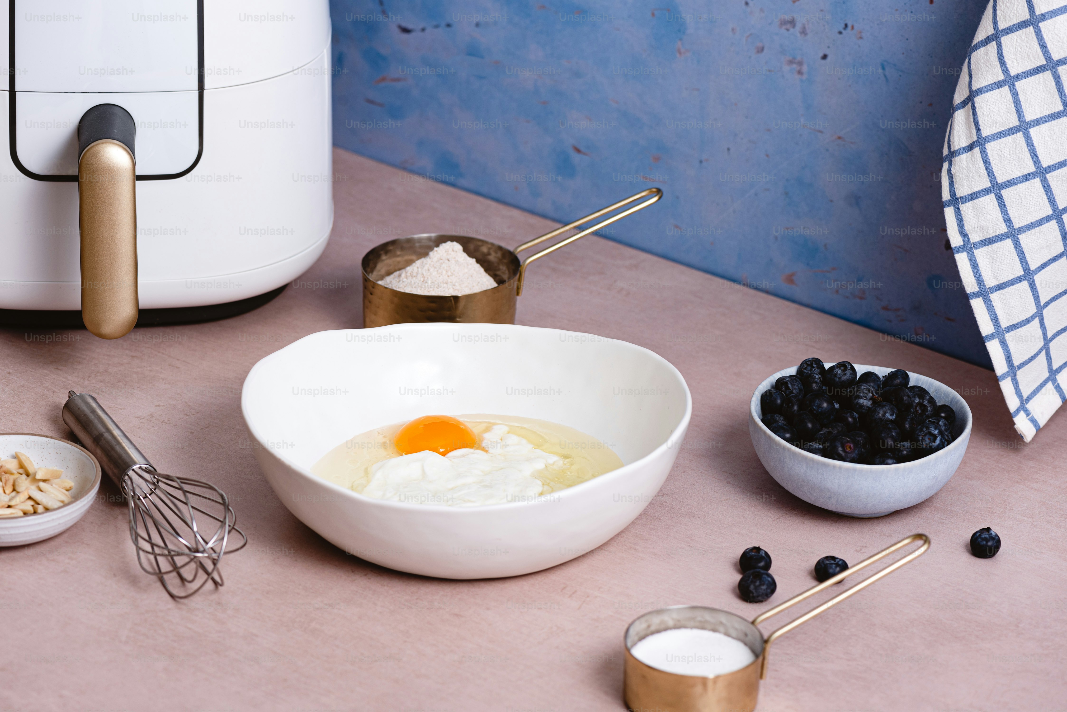 a table topped with bowls of food next to a blender