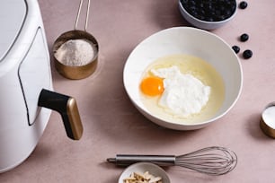 a bowl of eggs and other ingredients on a table