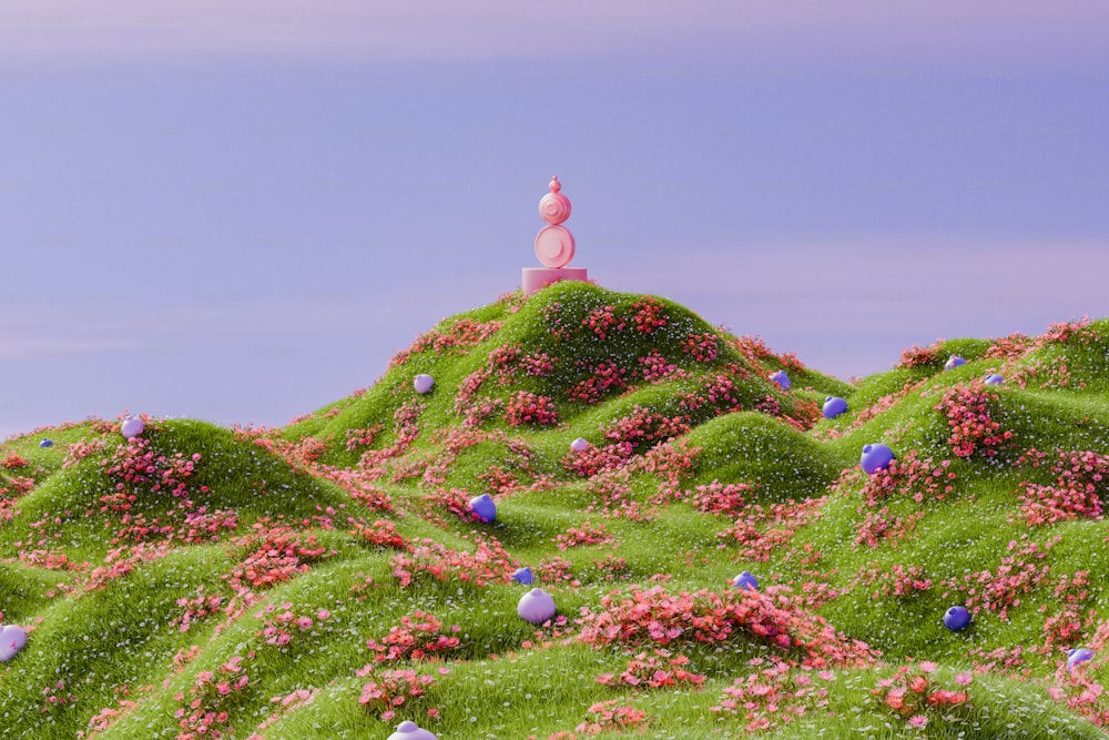 a hill covered in green grass and pink flowers